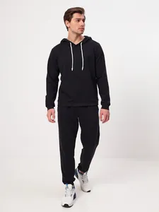 Full view of men's black fleece sweatpants and matching hoodie on a standing model