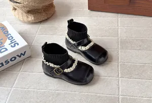Retro black girl's sock boots with delicate white lace trim and metal buckle details