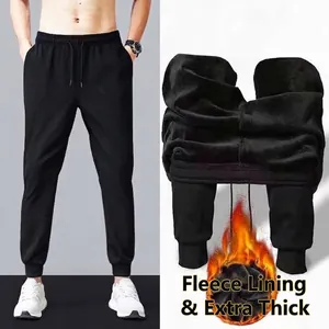 Detail of men's thermal black sports joggers showing the thick warm fleece interior lining.