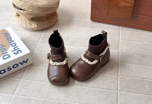 Detail of vintage girls' sock boots featuring knit collars and delicate lace trim