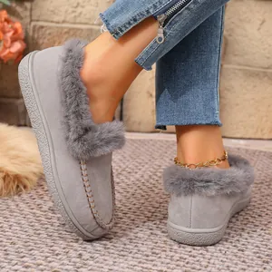 Close-up of grey faux suede loafers featuring plush grey fur trim and cozy warm lining.