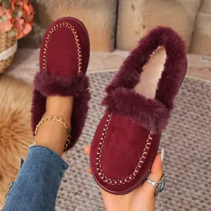 Detail showing the burgundy suede finish and thick faux-fur lining of warm winter loafers