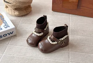 Close-up of the vintage lace trim and knit texture on brown retro girls' leather boots.