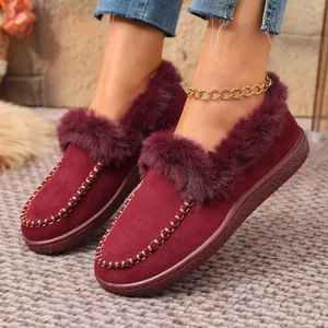 Detail view of stylish burgundy faux fur lined winter flat shoes with decorative stitching