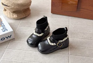 Vintage black toddler girl sock boots featuring delicate lace trim and buckle details.