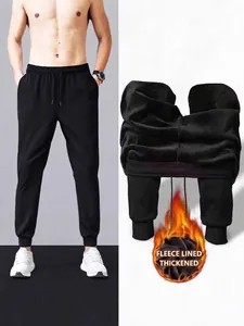 Men's black thermal fleece-lined sweatpants for winter warmth and sports.