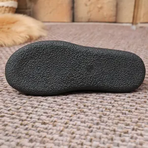 Close-up of the non-slip rubber sole texture on warm winter flat cotton shoes