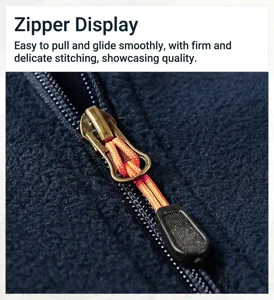 Detail showing high-quality bronze metal zipper and orange pull cord on fleece jacket.