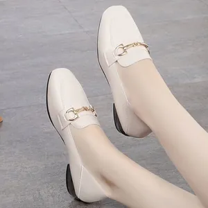 Elegant cream square toe loafers with gold horsebit buckle on model feet