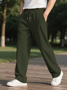 Detailed texture of dark green corduroy trousers for men in a casual outdoor setting