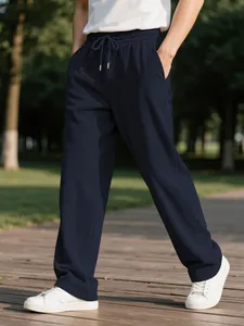 Close-up of men's navy blue corduroy trousers with elastic drawstring waist.