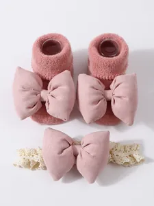 Conjunto de calcetines y diadema rosa para bebé con lazos para calor invernal.