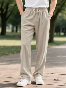 Men's beige corduroy casual pants with elastic drawstring waist shown in outdoor park setting.