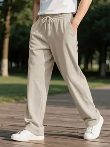 Detail view of men's beige corduroy casual trousers with elastic drawstring waist