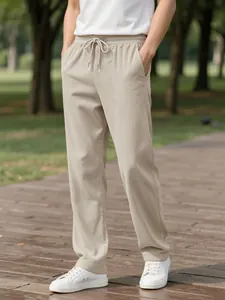 Detailed macro shot of men's casual beige corduroy trousers with an elastic drawstring waist.
