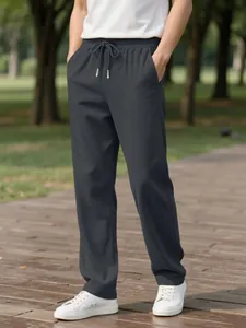 Outdoor casual look featuring dark gray men's corduroy trousers and sneakers