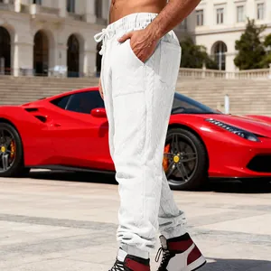 Detail of white heavyweight jacquard joggers featuring a unique textured knit pattern