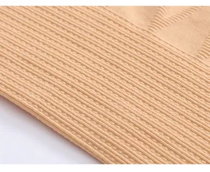Macro view showing the high-elasticity ribbed texture of beige shapewear fabric
