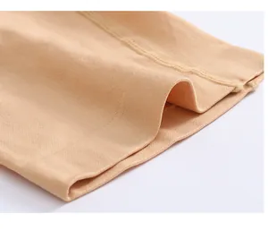 Macro detail of high-elastic nude shapewear fabric showing professional stitching.