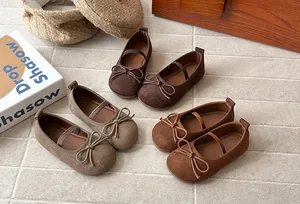 Detailed view of girls suede Mary Jane shoes with bowknots in various brown shades.