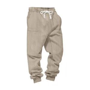Close-up of beige heavy jacquard jogger pants with cable knit pattern and white drawstring