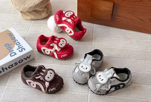 Close-up view of cartoon bunny baby sneakers showing red, grey and brown color options