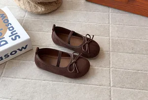Detailed view of brown suede girls' princess shoes with delicate bow knot