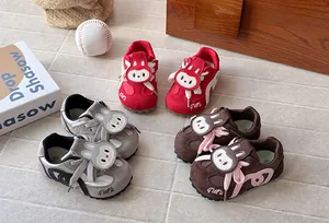 High-quality detail view of cartoon rabbit children's sports sneakers in red, grey, and brown.