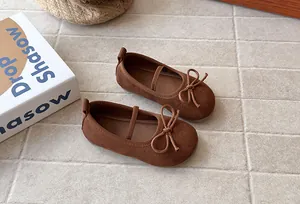 Detail view of brown matte girls' princess shoes with bow and soft sole decoration