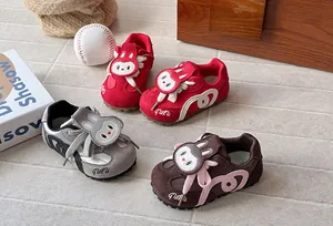 Detailed view of cartoon German trainer shoes for kids in red, grey, and brown colors