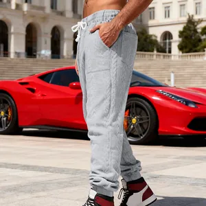 Detailed texture of grey heavy jacquard joggers for men in a casual outdoor setting