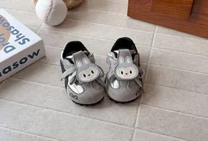 Detailed view of children's grey trainer shoes featuring a cute cartoon rabbit design