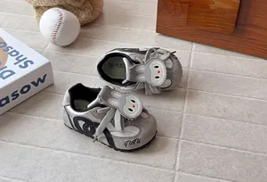 Detail of grey children's trainers featuring a cute cartoon rabbit on the tongue.