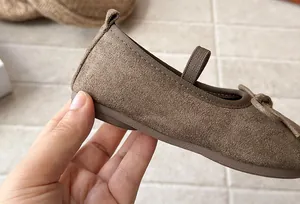 Detail of brown suede Mary Jane shoe for girls with bow accent