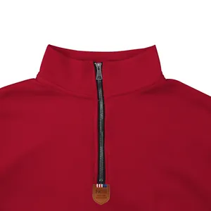 Close-up detail of a red heavy fleece sweatshirt with a high-quality metal quarter-zip.