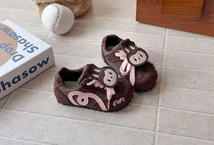 Brown and pink children's sneakers with cute cartoon rabbit character detail