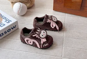 Detailed view of brown cartoon rabbit sneakers for children with soft soles