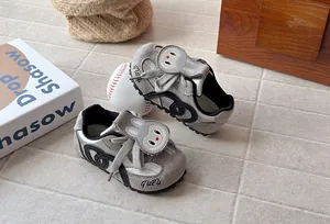 Detail view of grey children's sneakers with cute cartoon rabbit face and soft sole