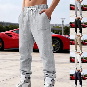 Close-up of men's heavy jacquard tapered joggers showing cable knit texture details