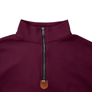 Detailed view of the collar and metal zipper on a burgundy fleece sweatshirt for men