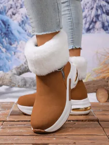 Stylish brown suede snow boots with white faux fur trim and gold platform accents