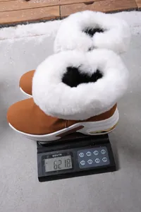 Detail view showing the lightweight 621.8g weight of the brown winter snow boots