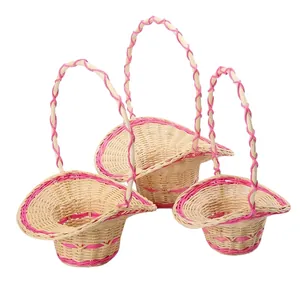 Set of three handmade rattan flower baskets with pink trim and handles for home decor