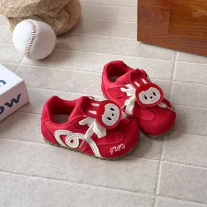 Stylish red kids German trainer sports shoes featuring a cute cartoon bunny patch