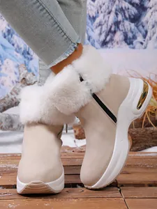 Stylish beige women's platform snow boots with fluffy white faux fur trim and gold accents