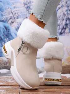 Detail view of beige snow boots with white faux fur collar and gold metallic sole accents