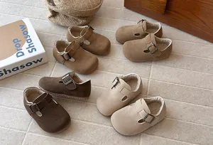 Retro kids' plush Birkenstock style shoes in multiple colors on a textured floor