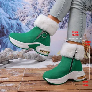 Green winter snow boots with white fur trim and thick platform sole height details