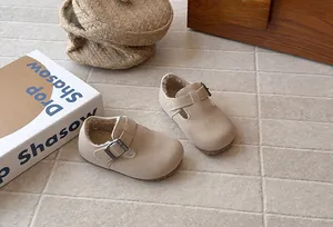 Detailed macro view of retro beige children's fleece-lined shoes with buckle strap