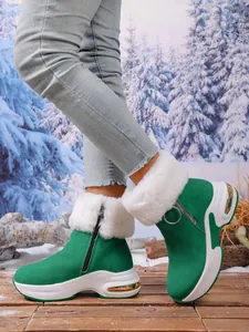Detailed view of green faux suede winter snow boots with white faux fur and thick soles